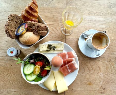 Coffee and platter full of meats, cheeses, and breads at Abella Garden Inn, Arroyo Grande